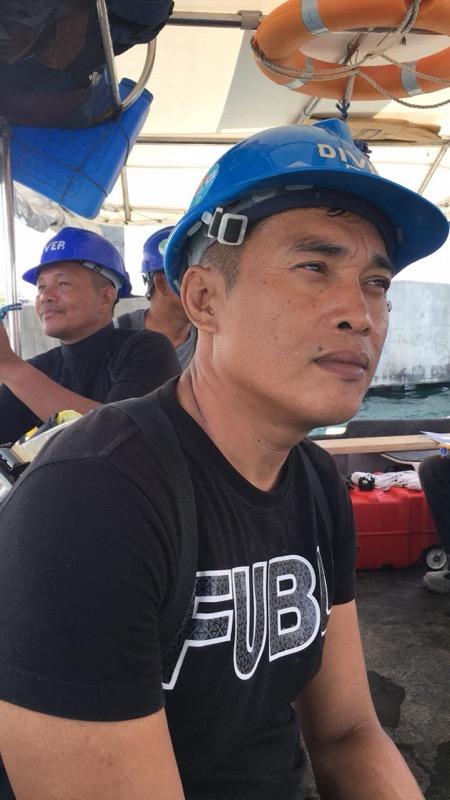 Crew member portrait with blue DIVER helmet